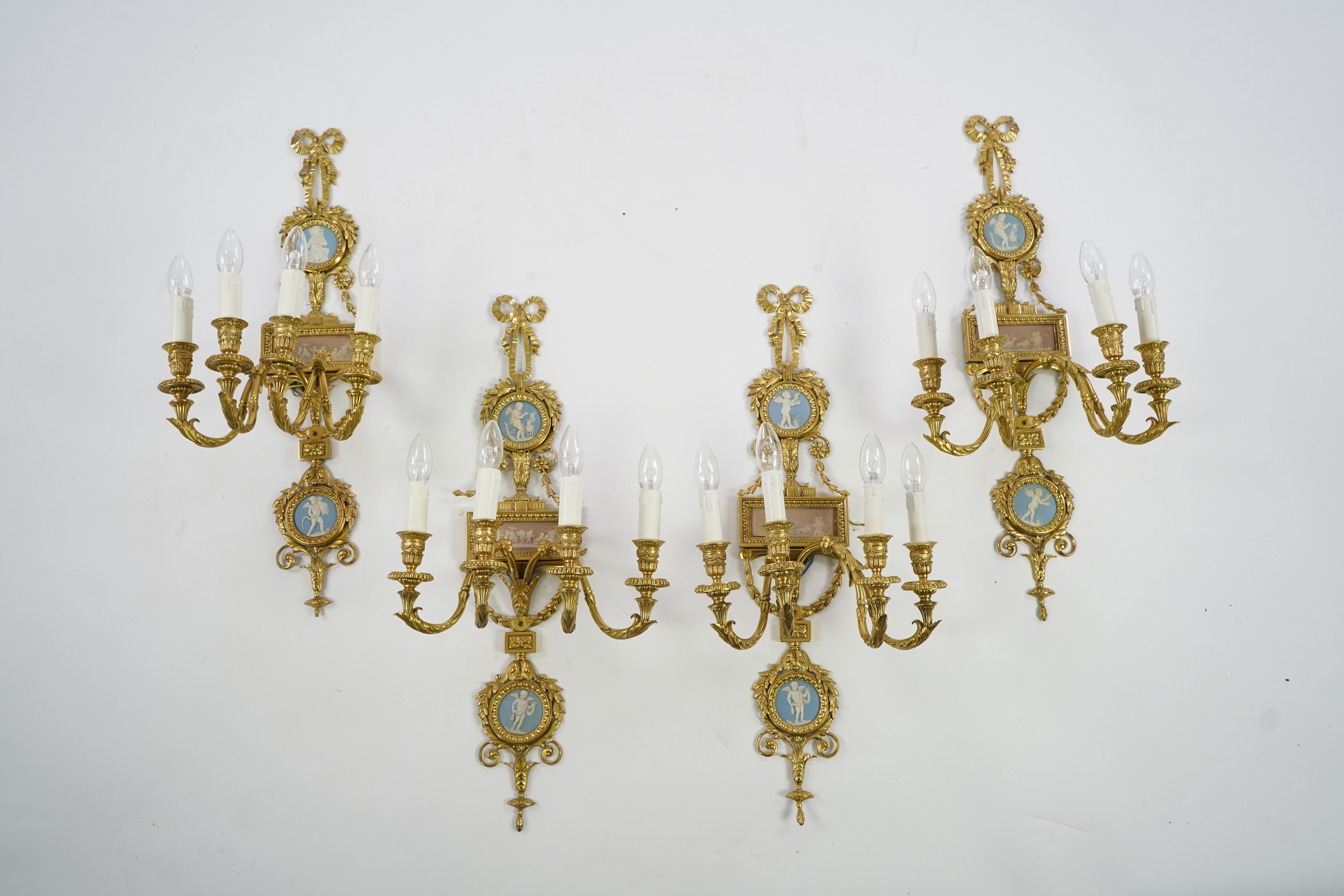 A set of four Adam style ormolu and jasper ware mounted wall appliques, early 20th century